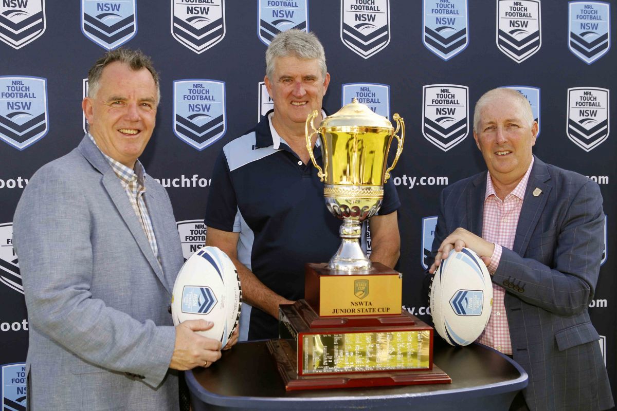 Three men standing behind trophy and holding footballs at the launch of the 2023 NSWTA Junior State Cup Southern Conference carnival, (from left) Wagga Wagga Mayor Cr Dallas Tout, Wagga Wagga Touch Association life member and NSWTA Vice President Chris Dolahenty, and NSWTA General Manager Dean Russell.