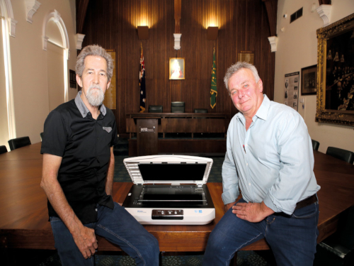 PRESERVE AND PROTECT: Wagga Wagga and District Historical Society President Geoff Burch (left) and Museum of the Riverina Manager Luke Grealy in the Historic Council Chambers after unpacking the new scanner which is now in work protecting and preserving the city's local history.