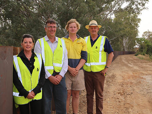 Inspecting the sheetpiling work along the levee bank adjacent to Tarcutta Street is (from left) Council's Director Commercial Operations Caroline Angel, Manager Council Business Darryl Woods, Site Manager Toby Daniel and Wagga Wagga Mayor Cr Greg Conkey OAM.