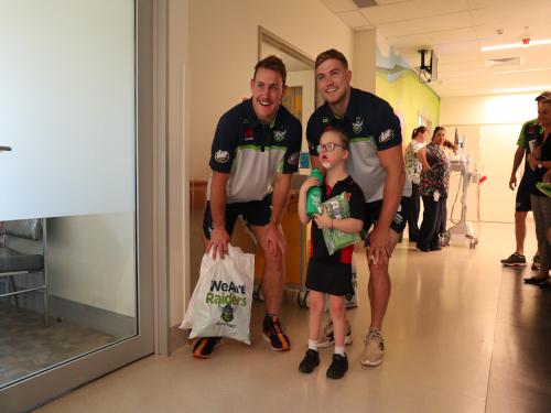 Raiders duo Luke Bateman and Hudson Young pose for a photo with Sophie Way. Sophie will celebrate her 9th birthday on Monday.