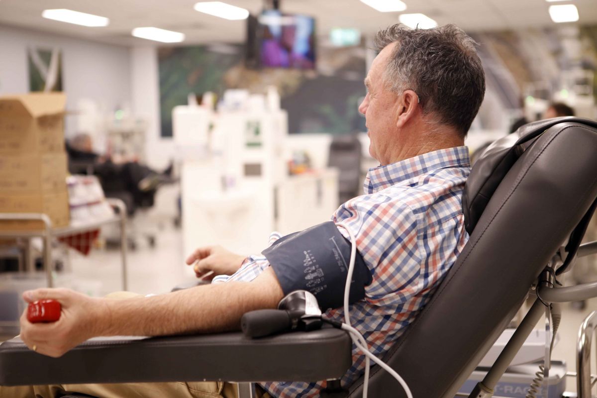 Side view of Wagga Mayor Councillor Dallas in chair, donating blood
