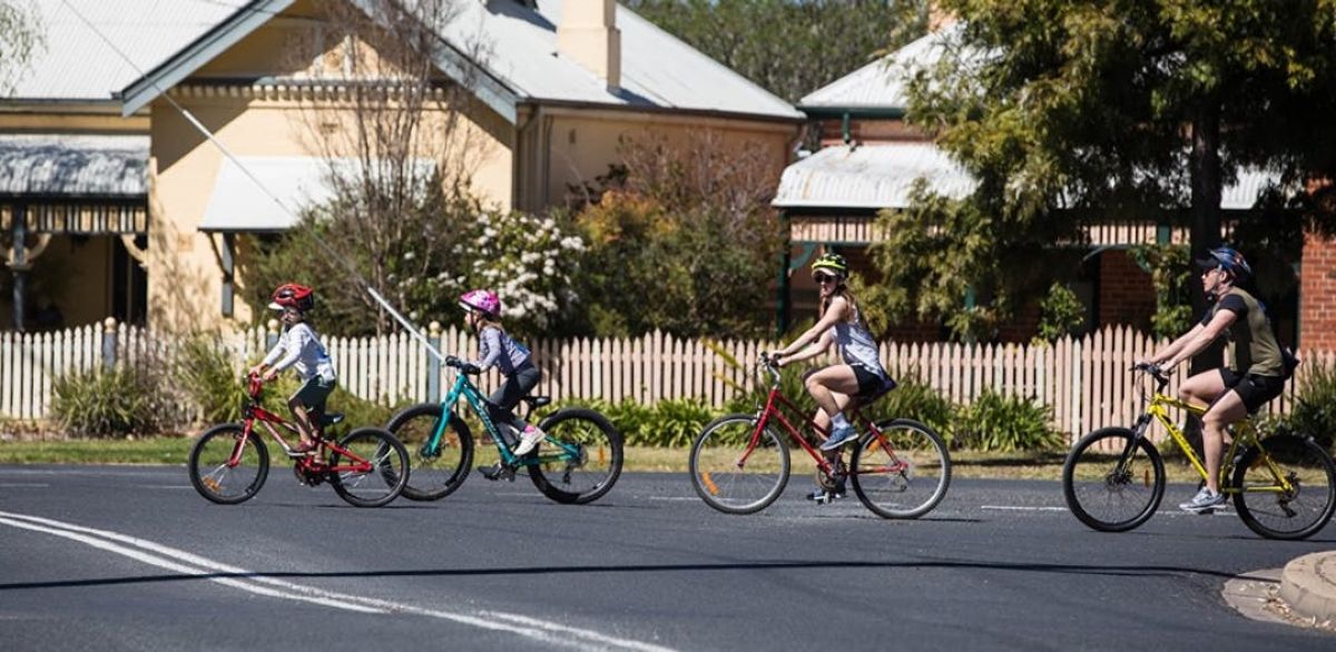 Family cycling near Wollundry Lagoon Active Travel Plan